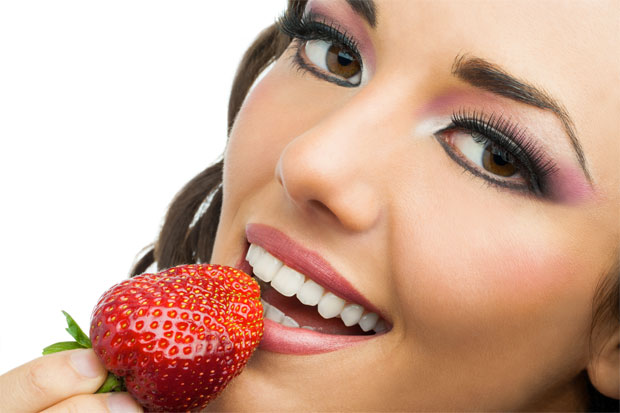 girl eating strawberry