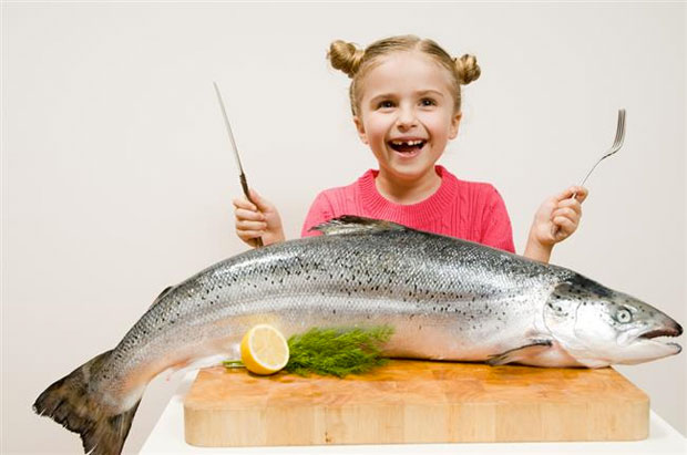 kid eating fish