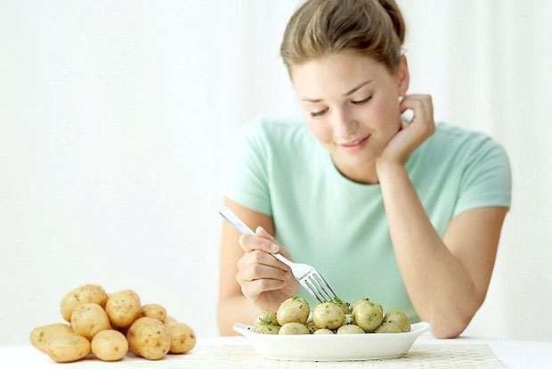 woman eating potato